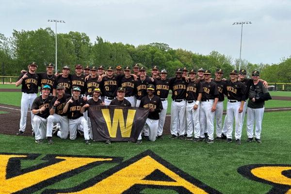 a group of people posing for a photo on a baseball field